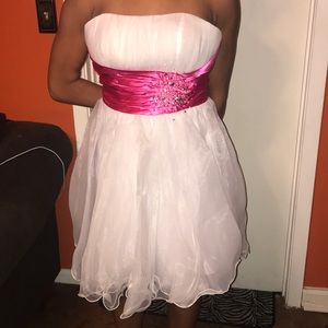 White Dress with Pink sparkly sash across it.